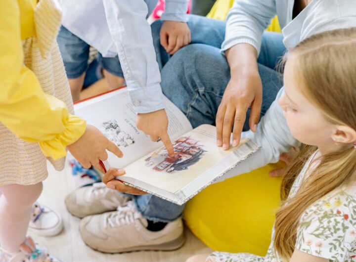 Preschool children gathered around a teacher reading a storybook indoors.